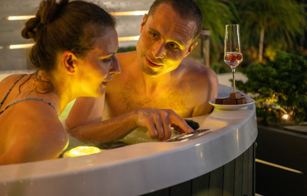 A couple enjoying a late-night date in a hot tub.