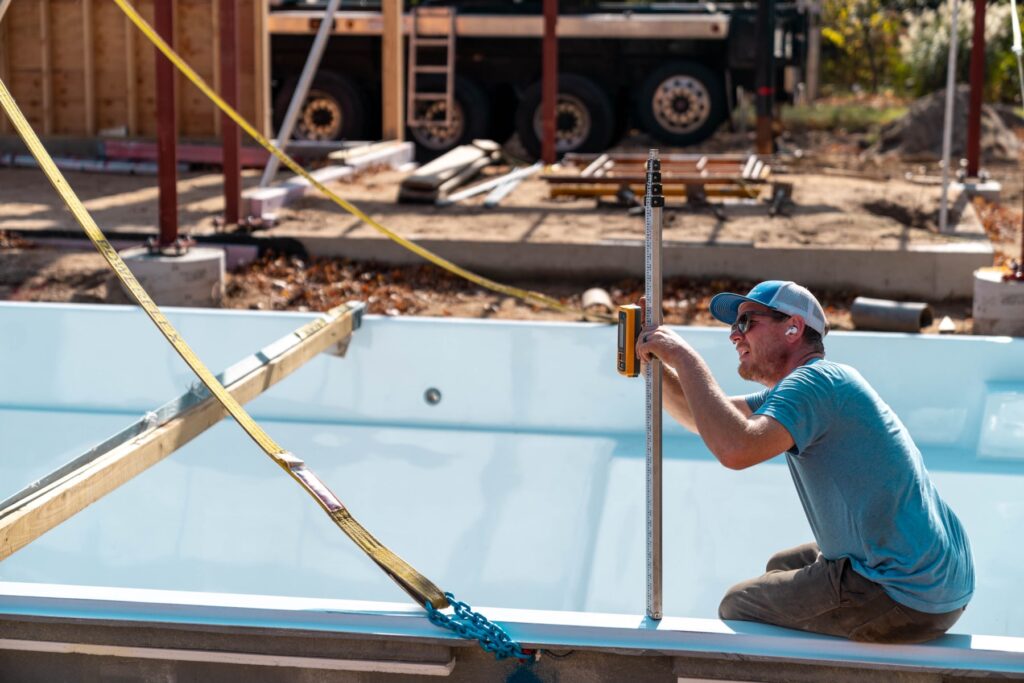 Locey's team helping a client build a new fiberglass pool.